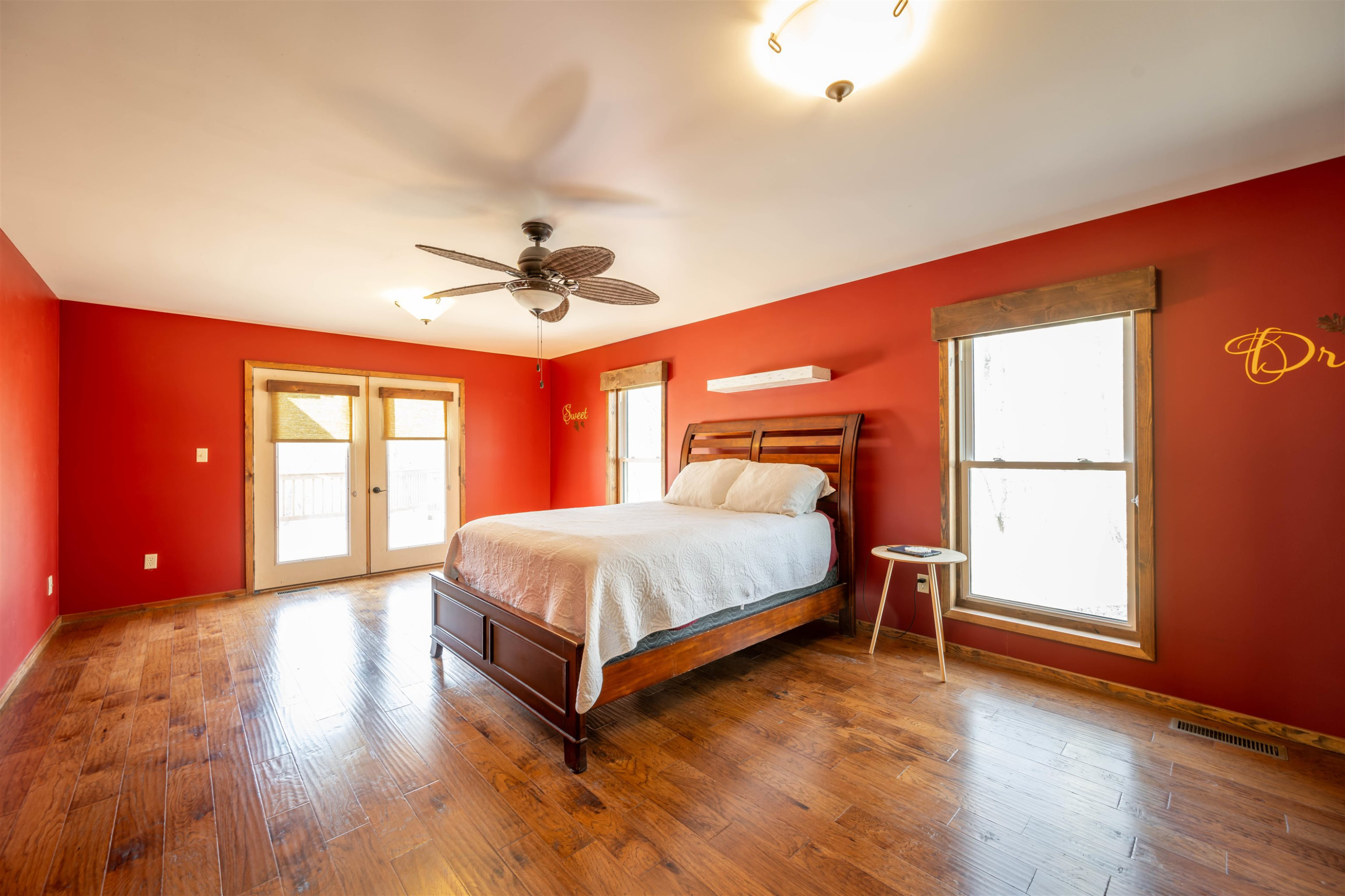 576 Ridgeway Road Sugar Tree, TN 38380 - Photo 27 of 66 a bedroom with a bed and wooden floor