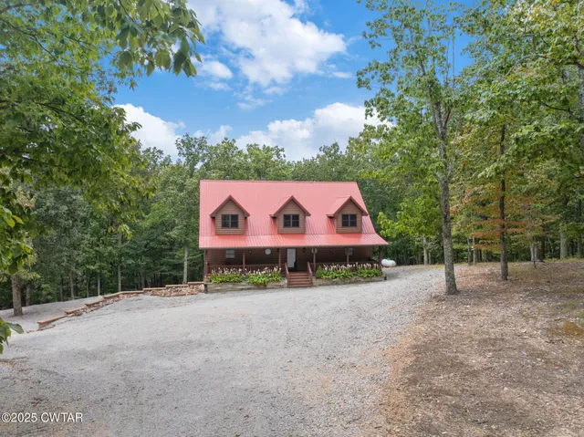 a view of house with a chairs and table in patio
