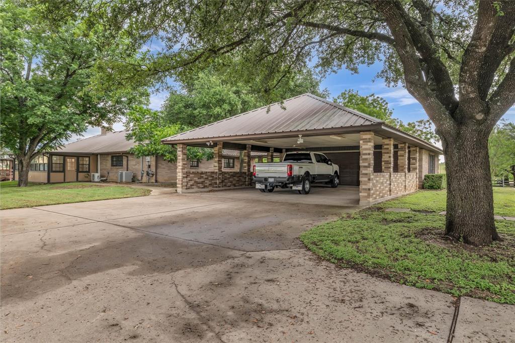 15796 Chapel Road Lorena, TX 76655 - Photo 9 of 28 View of front of home featuring brick siding, driveway, a front lawn, and an attached carport