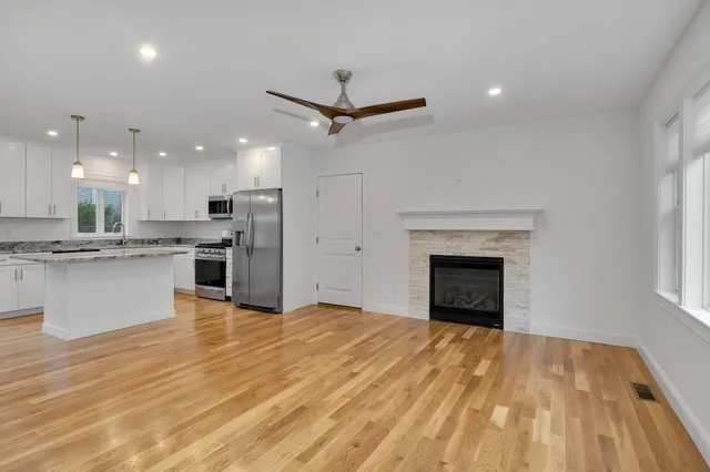 a view of kitchen with kitchen island microwave and stove