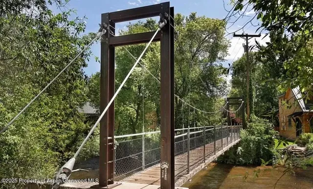 a kitchen with stainless steel appliances granite countertop a stove and a dining table