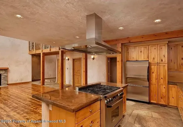 a kitchen with stainless steel appliances granite countertop a stove a refrigerator and a refrigerator