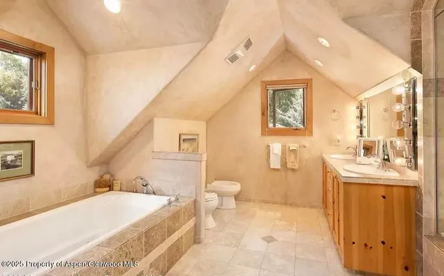 a view of a large room with kitchen and windows