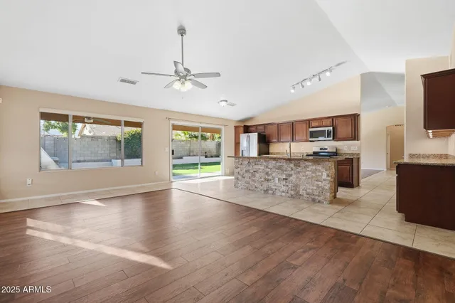 a kitchen with granite countertop a sink and a stove