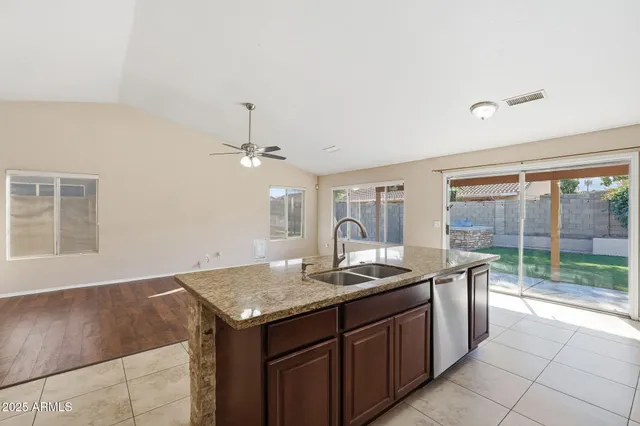 a kitchen with granite countertop a sink and stainless steel appliances