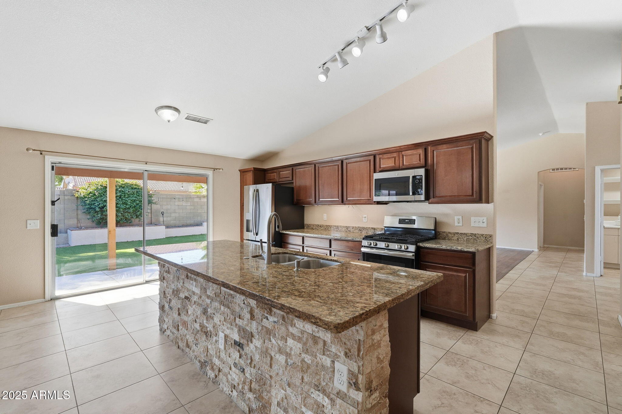 1619 East Carter Road Phoenix, AZ 85042 - Photo 15 of 56 a kitchen with stainless steel appliances granite countertop a stove top oven a sink a counter top space and cabinets