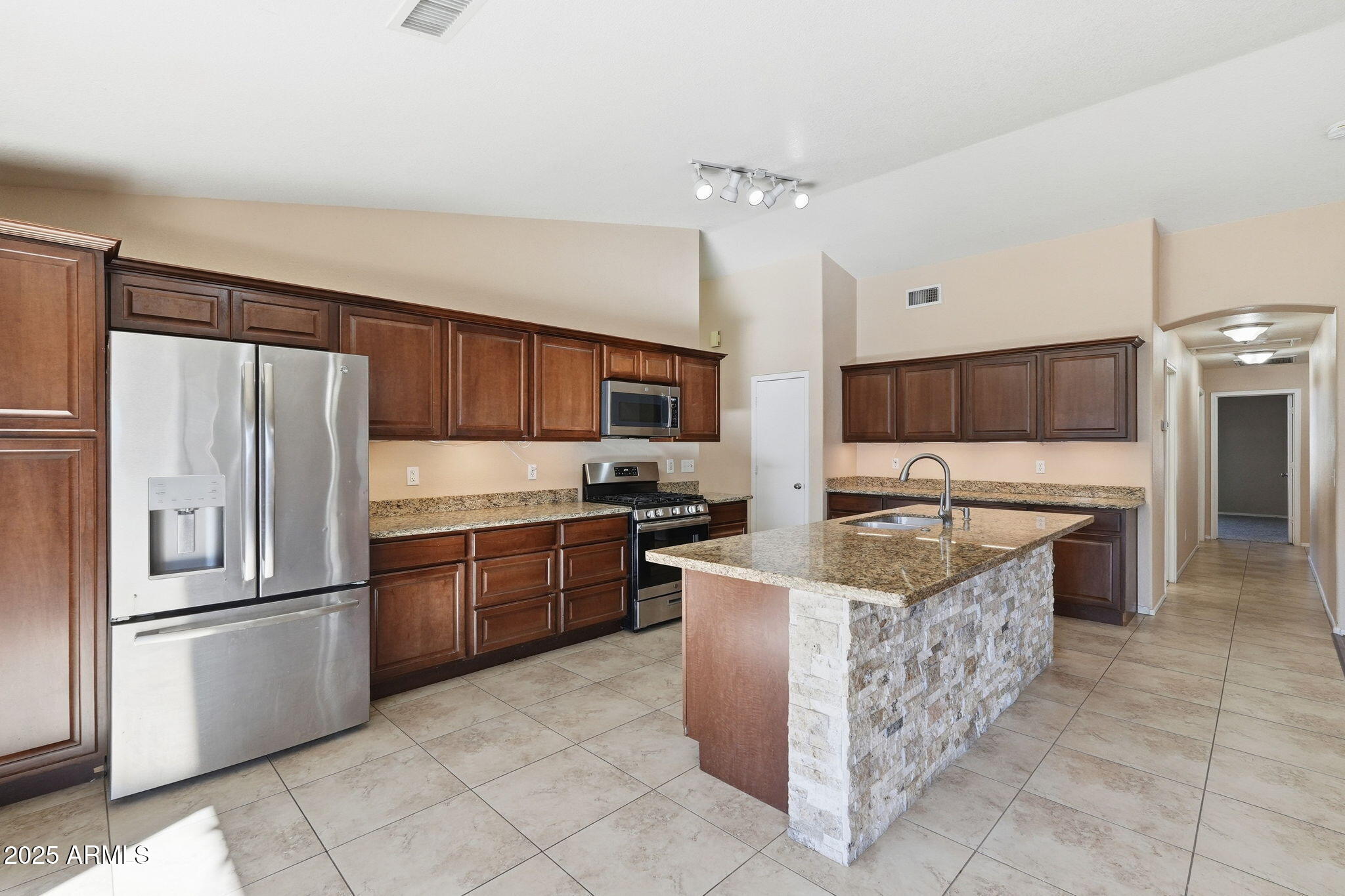 1619 East Carter Road Phoenix, AZ 85042 - Photo 16 of 56 a kitchen with granite countertop a sink and stainless steel appliances