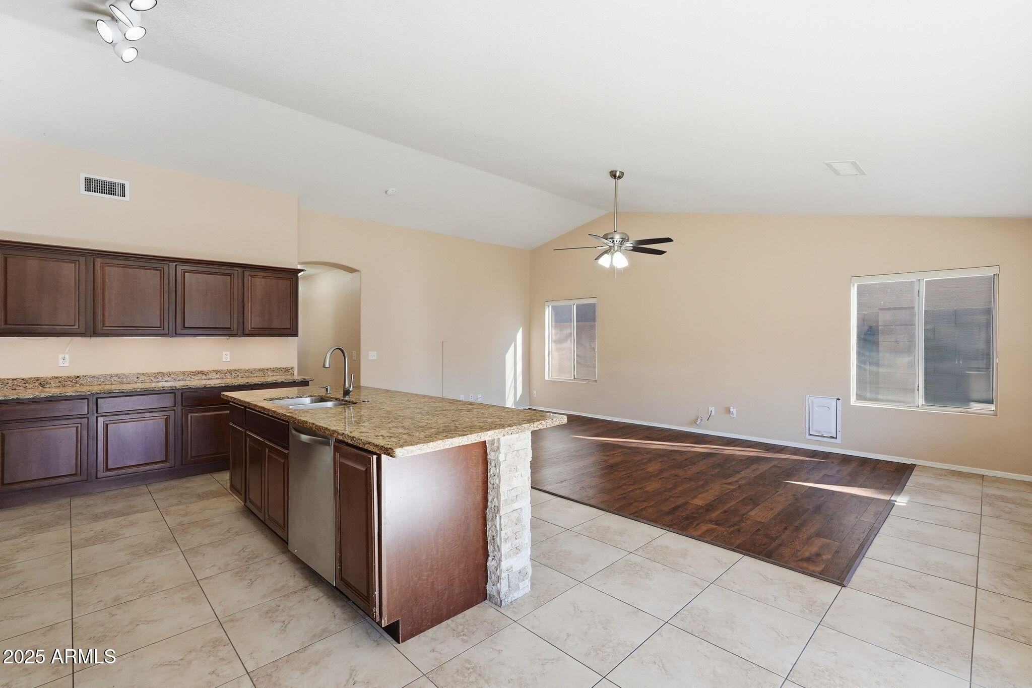 1619 East Carter Road Phoenix, AZ 85042 - Photo 17 of 56 a kitchen with stainless steel appliances granite countertop a stove a sink and a microwave