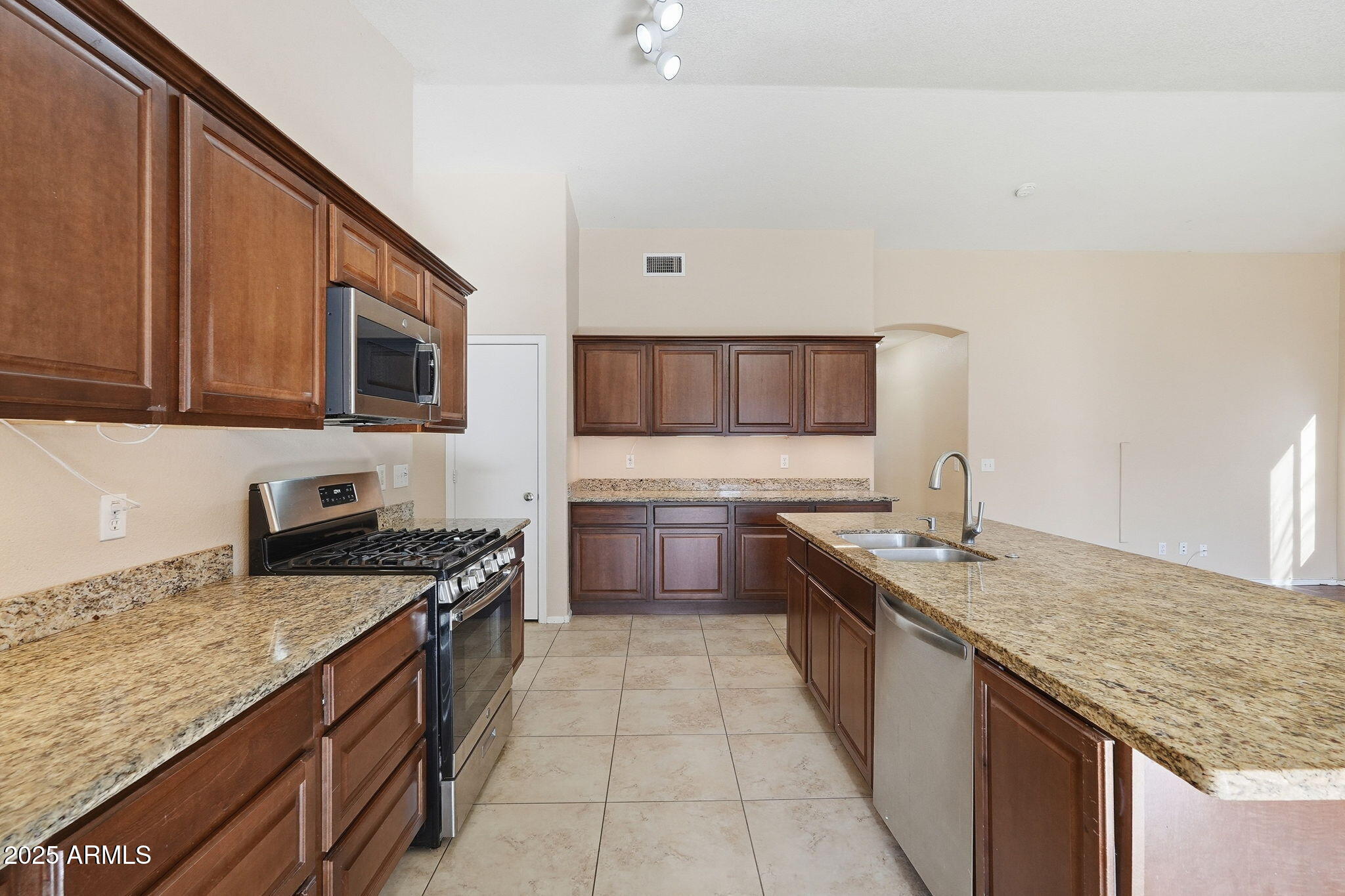 1619 East Carter Road Phoenix, AZ 85042 - Photo 18 of 56 a kitchen with stainless steel appliances granite countertop a sink stove and oven