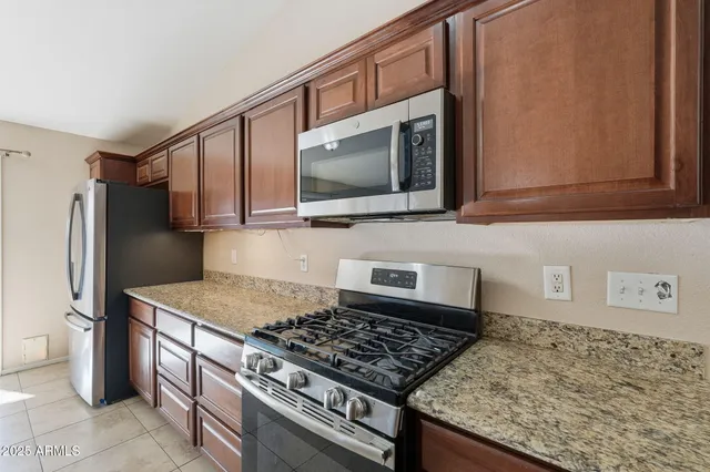 a view of a kitchen with a sink and a stove top oven