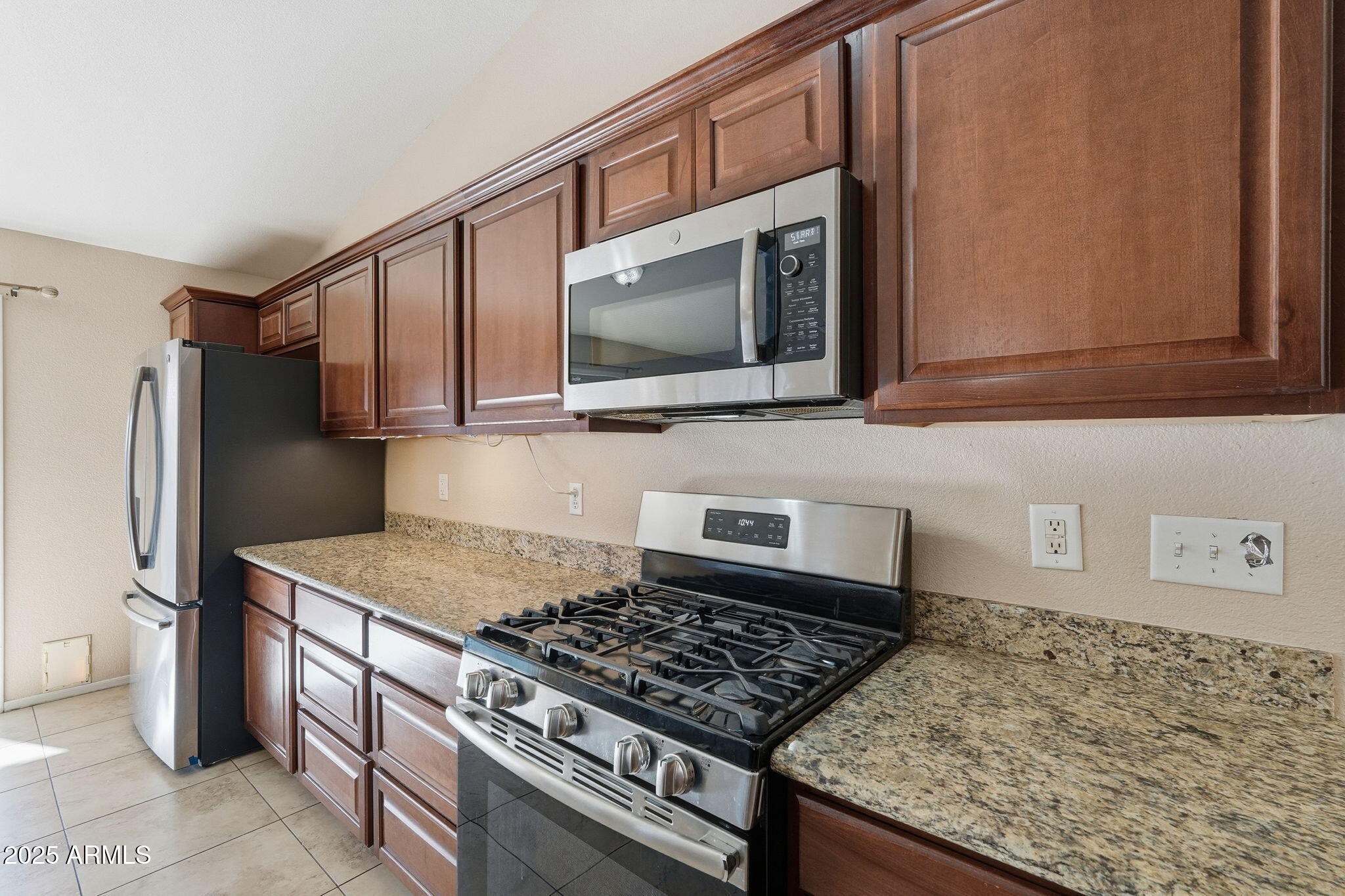 1619 East Carter Road Phoenix, AZ 85042 - Photo 19 of 56 a kitchen with stainless steel appliances granite countertop a sink stove and refrigerator