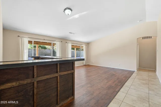 an empty room with a ceiling fan and a window