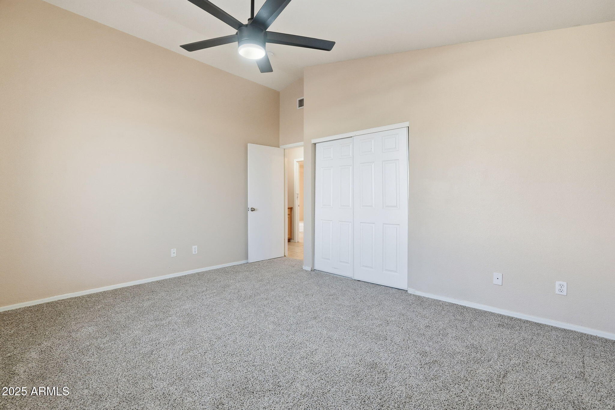 1619 East Carter Road Phoenix, AZ 85042 - Photo 27 of 56 an empty room with a ceiling fan and a window