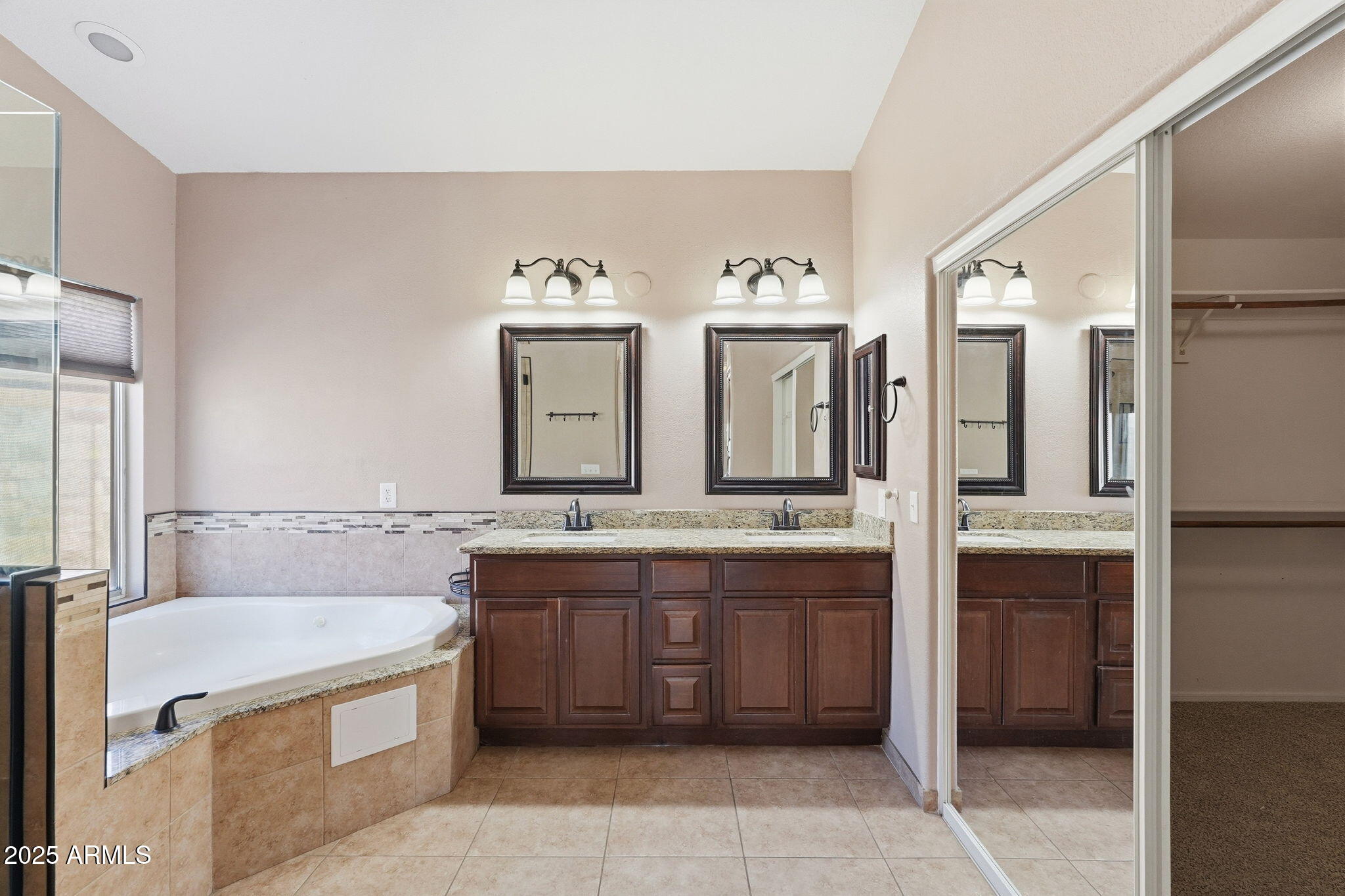 1619 East Carter Road Phoenix, AZ 85042 - Photo 38 of 56 a large bathroom with a double vanity sink mirror and bathtub