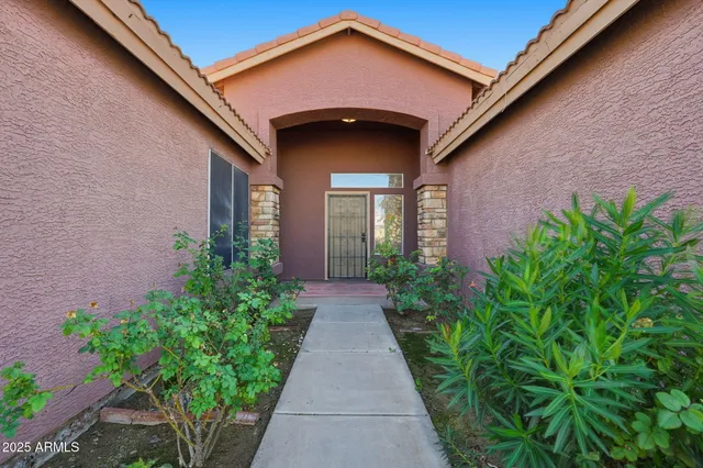 a view of a brick house with potted plants