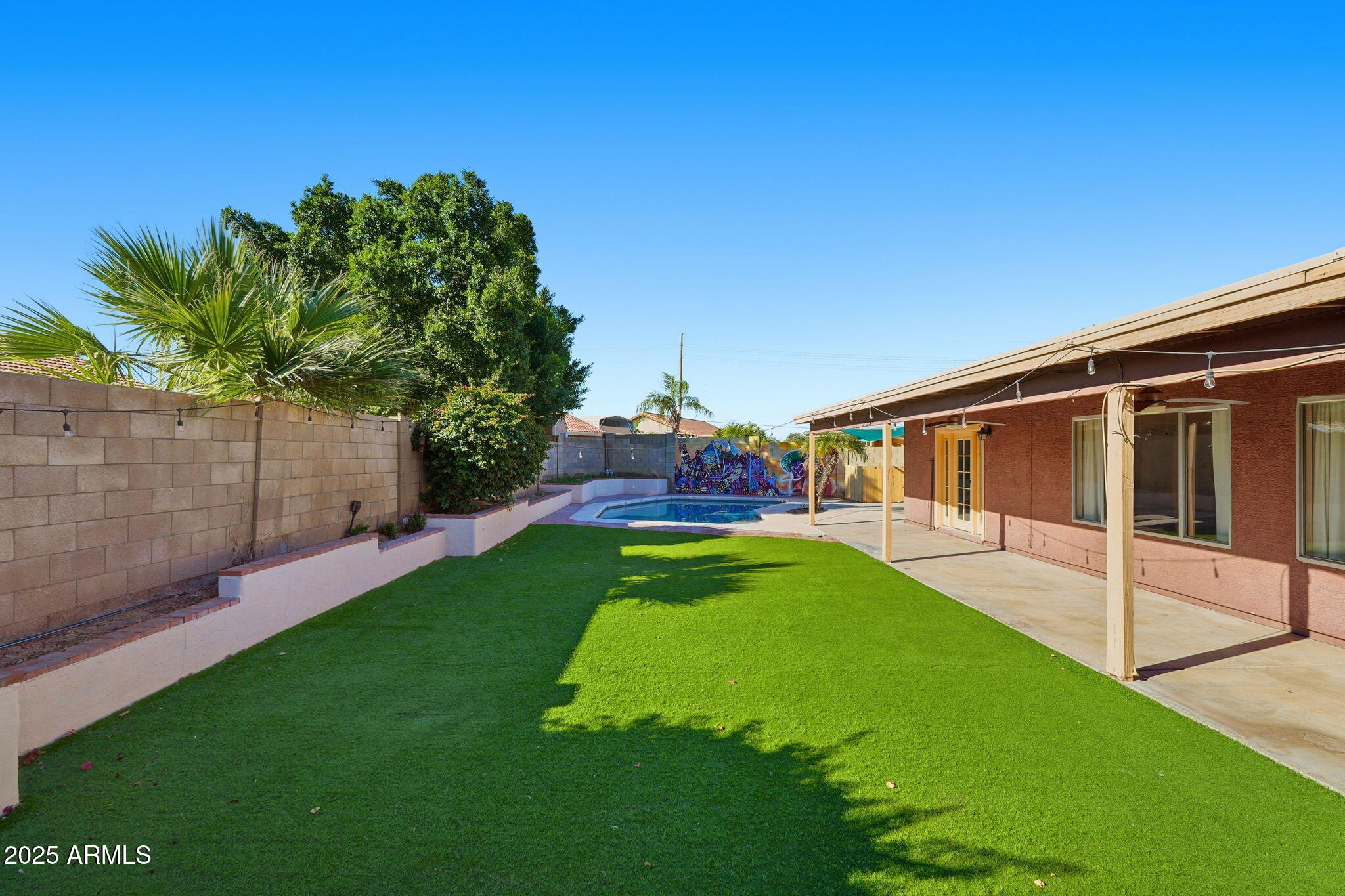 1619 East Carter Road Phoenix, AZ 85042 - Photo 49 of 56 a view of a backyard with table and chairs and potted plants