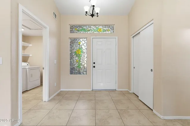 a room with wooden floor and potted plant on a table