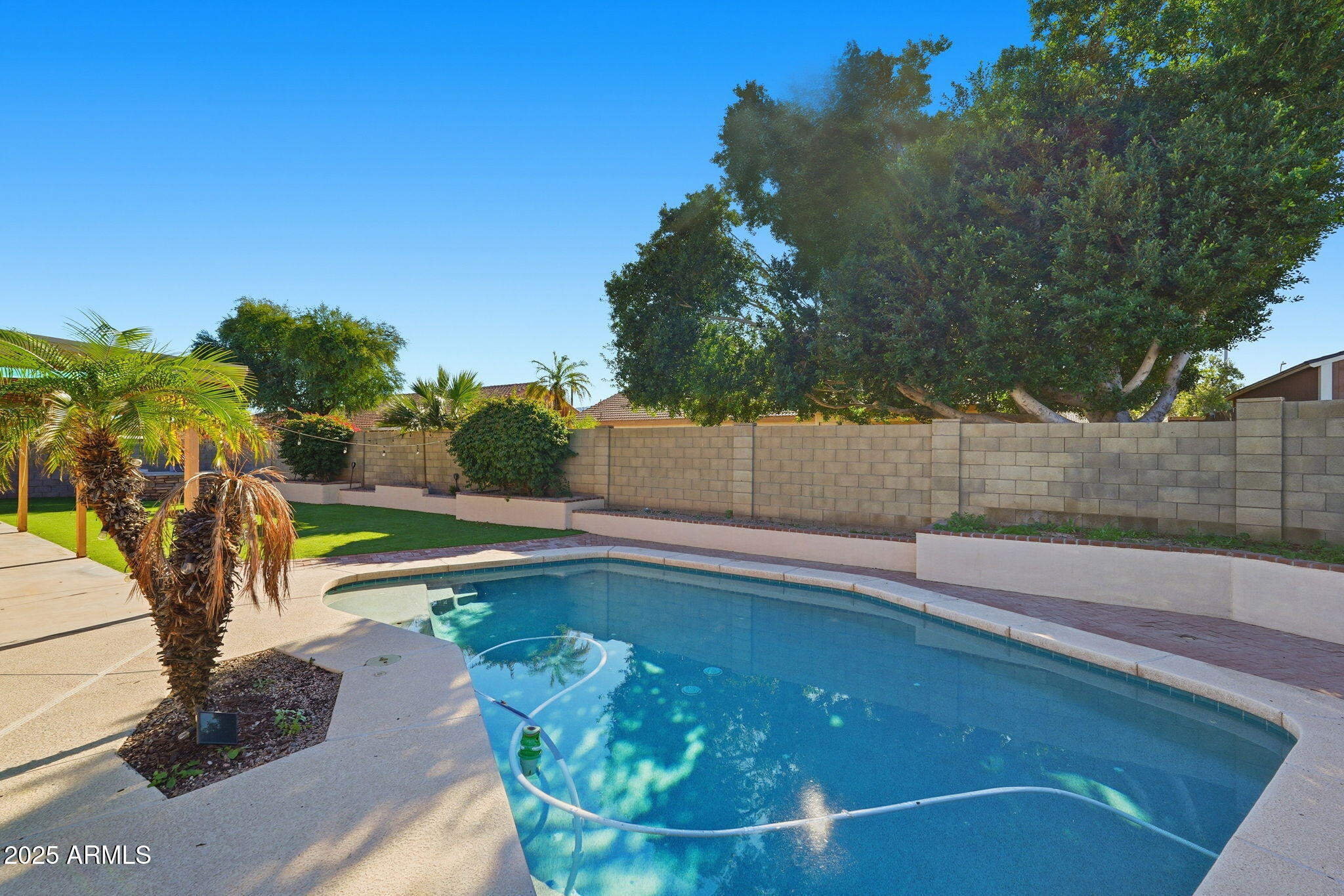 1619 East Carter Road Phoenix, AZ 85042 - Photo 53 of 56 a view of a swimming pool with a yard and seating area