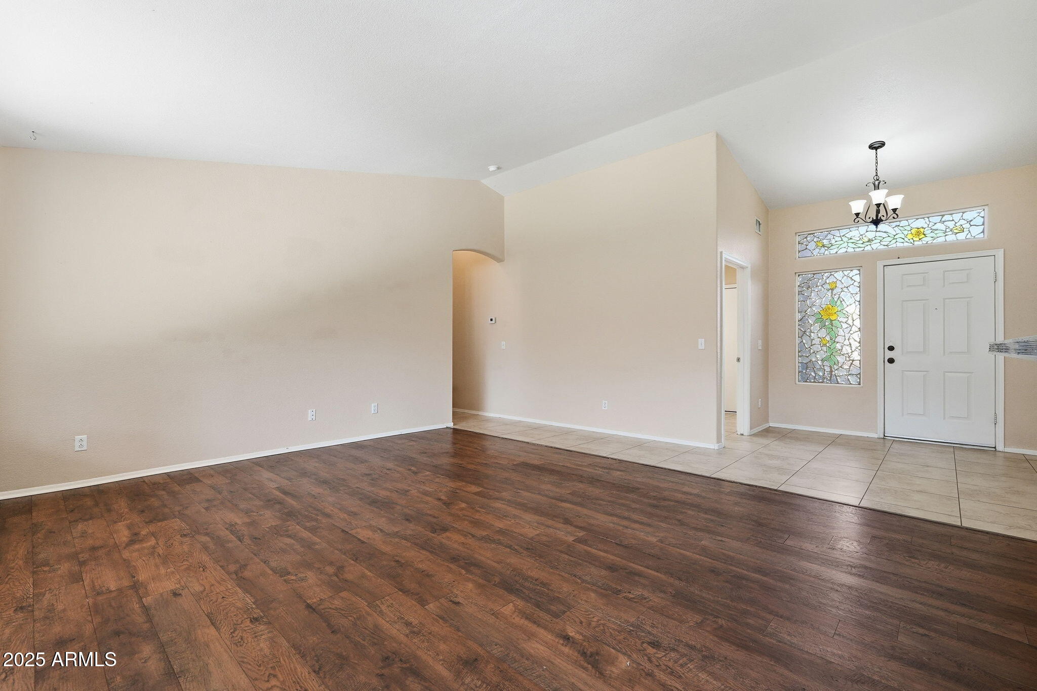 1619 East Carter Road Phoenix, AZ 85042 - Photo 10 of 56 an empty room with wooden floor and mirror