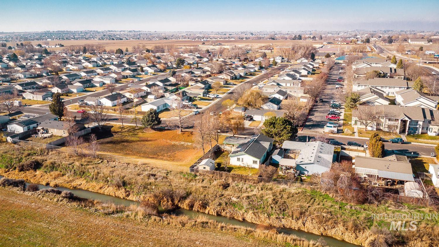 Aerial view of property's location with nearby suburban area