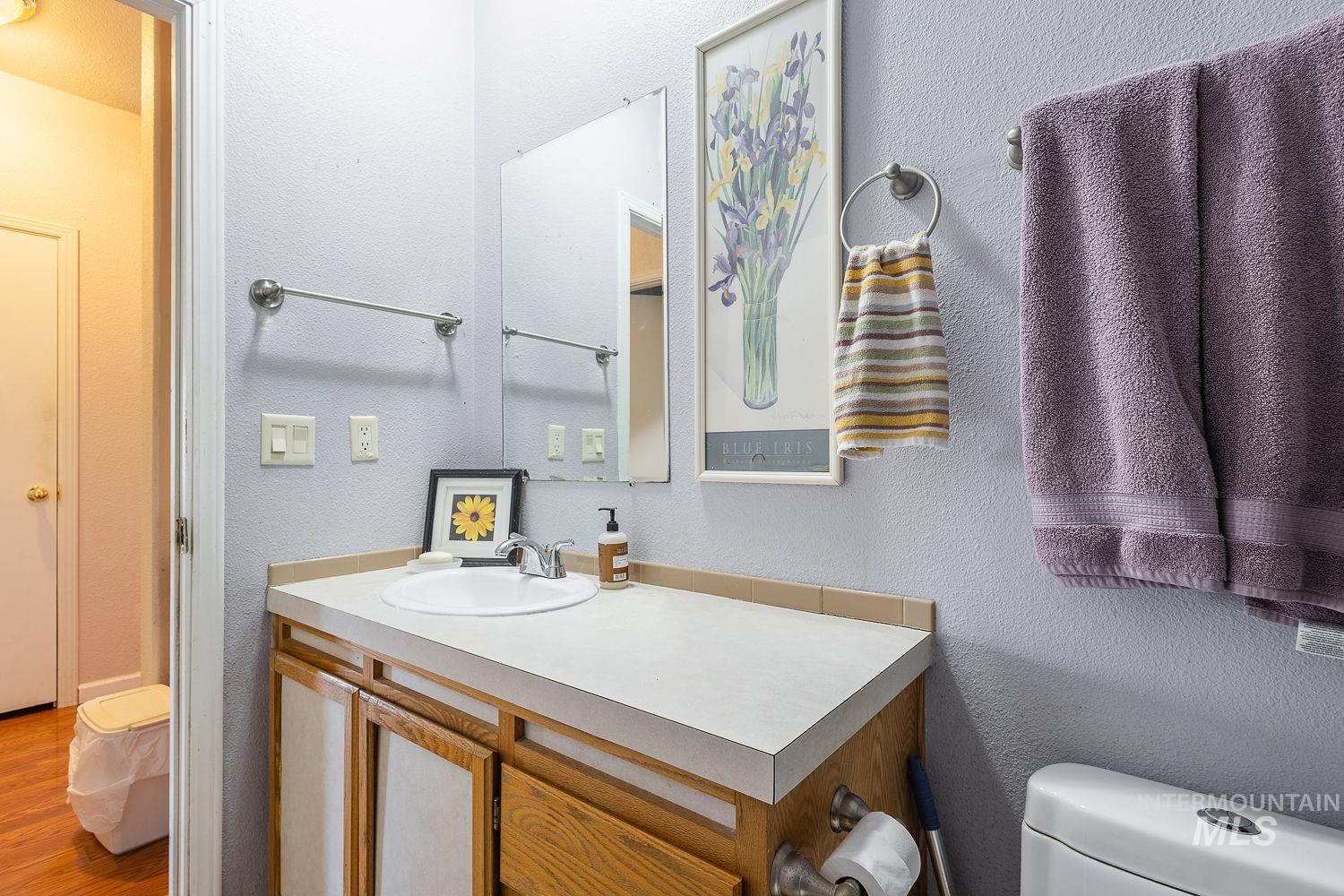 4119 Ashton Avenue Caldwell, ID 83607 - Photo 37 of 50 Half bathroom featuring a textured wall and vanity