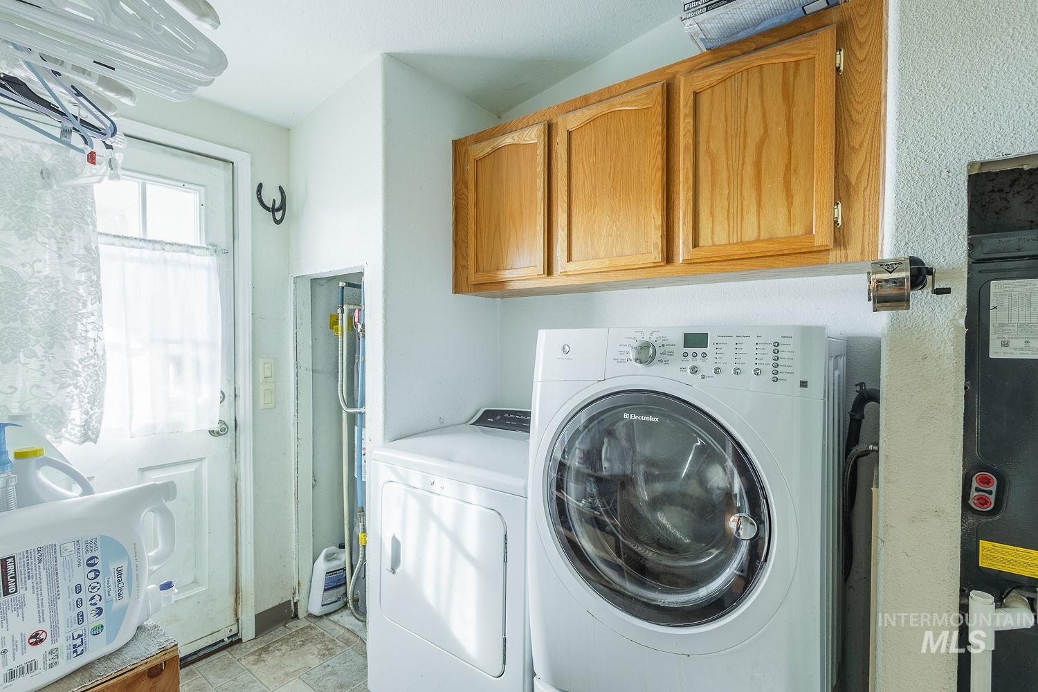 4119 Ashton Avenue Caldwell, ID 83607 - Photo 39 of 50 Laundry area with washer and clothes dryer and cabinet space