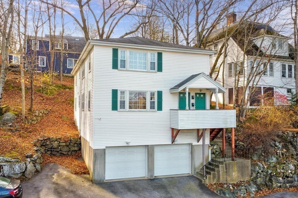 6 Dundee Road, Unit 6 Arlington, MA 02476 - Photo 2 of 29 a front view of a house with garage