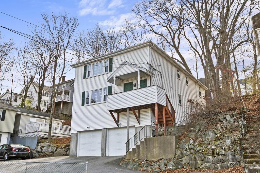 6 Dundee Road, Unit 6 Arlington, MA 02476 - Photo 4 of 29 a view of a white building among the street with large trees