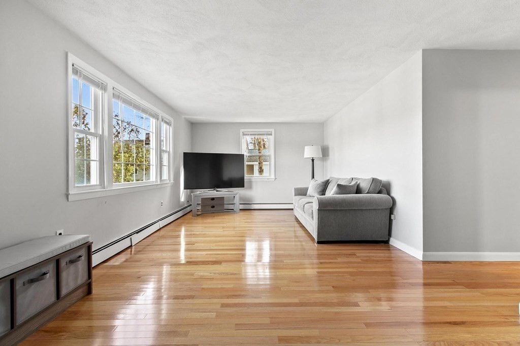 6 Dundee Road, Unit 6 Arlington, MA 02476 - Photo 7 of 29 a living room with furniture and a flat screen tv