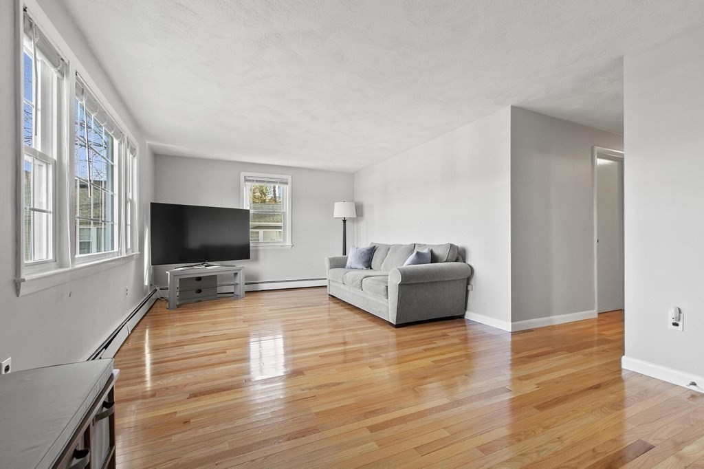 6 Dundee Road, Unit 6 Arlington, MA 02476 - Photo 8 of 29 a living room with furniture and a flat screen tv
