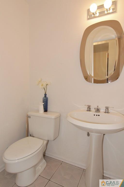 62 Harding Avenue Edison, NJ 08820 - Photo 13 of 24 a bathroom with a toilet a sink and mirror