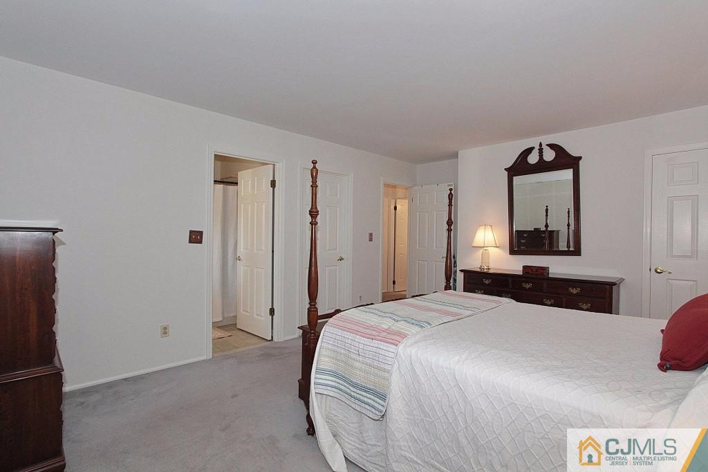 62 Harding Avenue Edison, NJ 08820 - Photo 15 of 24 a bedroom with a bed and a mirror
