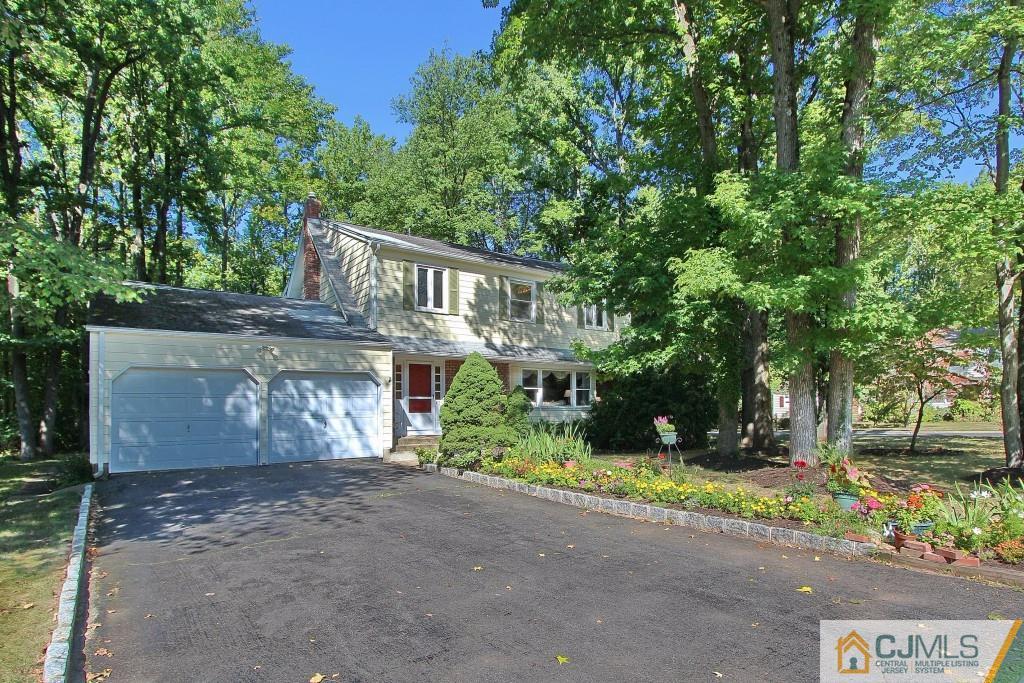 62 Harding Avenue Edison, NJ 08820 - Photo 3 of 24 a front view of a house with a yard and a garden