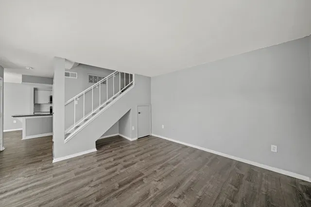 a view of staircase with lots of frames on wall and a window