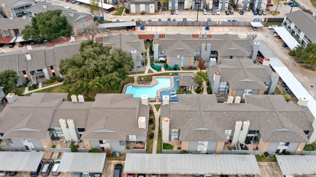 a view of a tennis ground with large trees