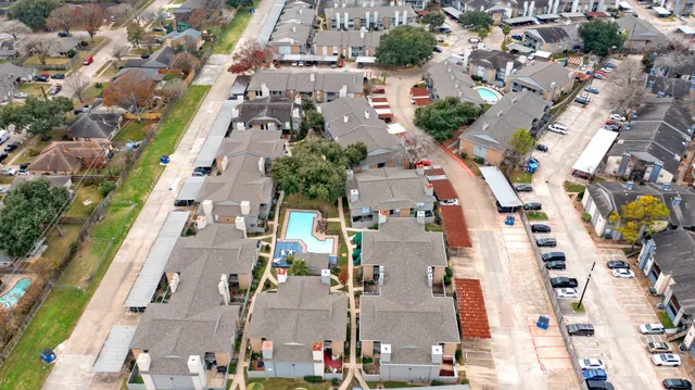 an aerial view of residential houses with outdoor space and street view