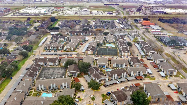 an aerial view of residential houses with outdoor space