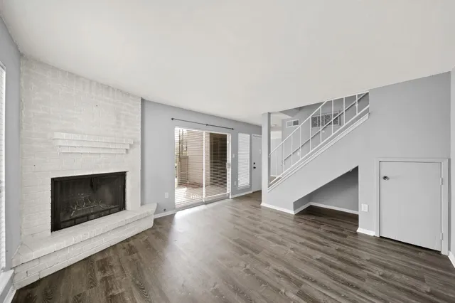 wooden floor in an empty room with a fireplace