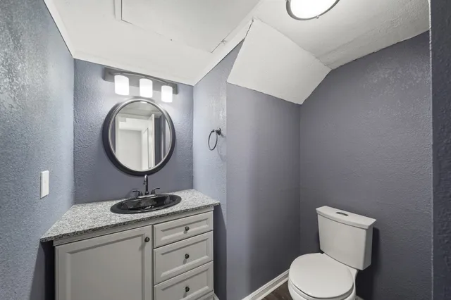 a view of an empty room with wooden floor fireplace and a window