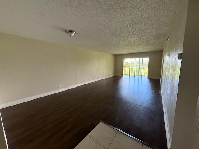 6101 North Falls Cir Drive, Unit 402 Lauderhill, FL 33319 - Photo 6 of 20 an empty room with wooden floor and windows
