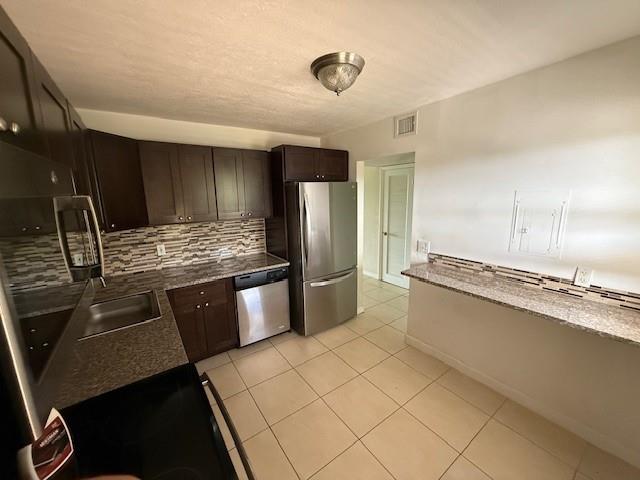6101 North Falls Cir Drive, Unit 402 Lauderhill, FL 33319 - Photo 7 of 20 a large kitchen with a large counter top appliances and cabinets
