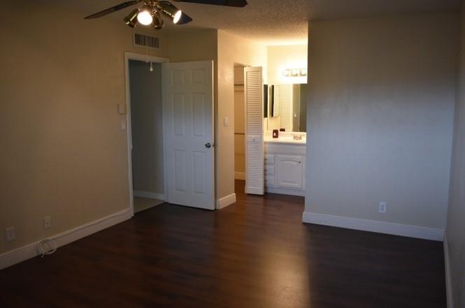 6101 North Falls Cir Drive, Unit 402 Lauderhill, FL 33319 - Photo 10 of 20 an empty room with wooden floor and windows