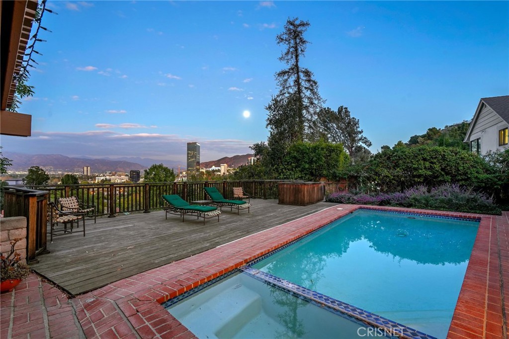 3620 Wrightwood Drive Studio City, CA 91604 - Photo 1 of 39 a view of a swimming pool with a patio