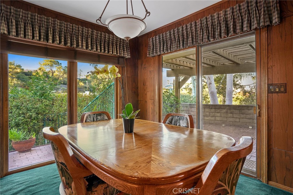 3620 Wrightwood Drive Studio City, CA 91604 - Photo 21 of 39 a dining room with glass top table and chairs