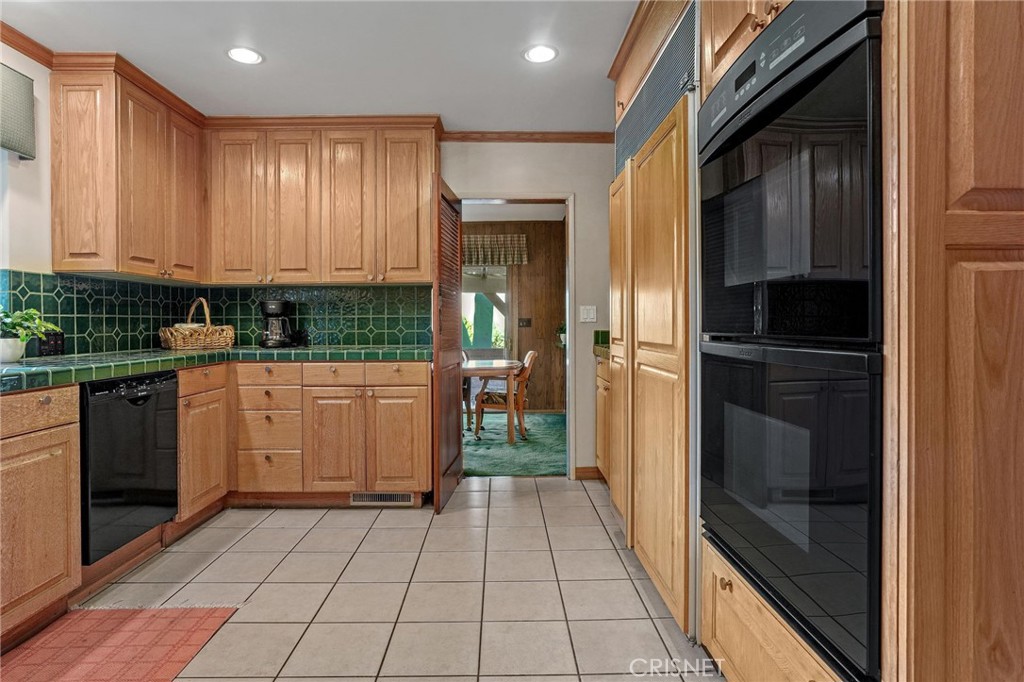 3620 Wrightwood Drive Studio City, CA 91604 - Photo 24 of 39 a kitchen with a refrigerator a stove top oven and cabinets