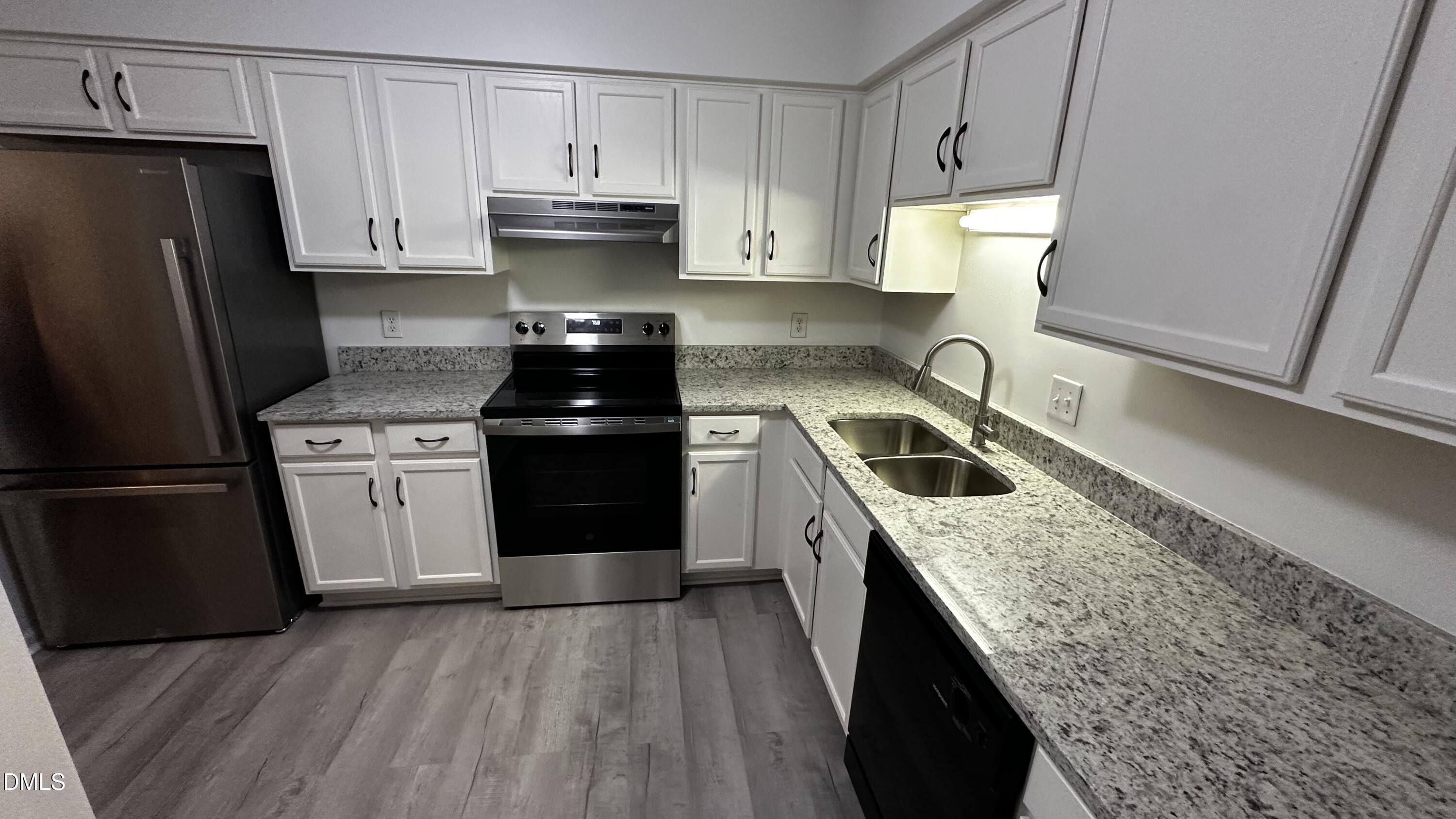 4705 Fargo Court, Unit B Raleigh, NC 27612 - Photo 2 of 6 a kitchen with a stove sink and refrigerator