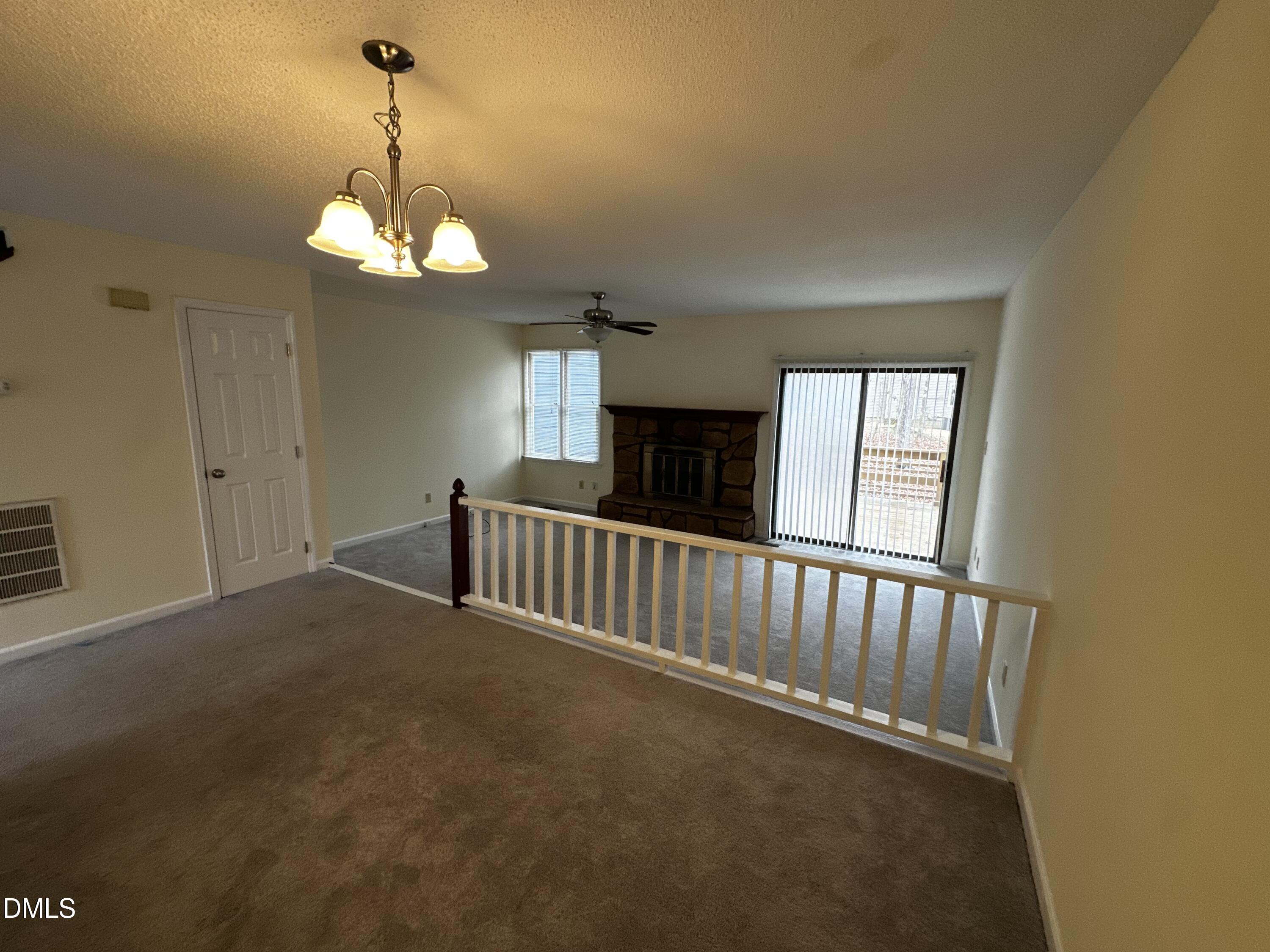 4705 Fargo Court, Unit B Raleigh, NC 27612 - Photo 3 of 6 a view of a livingroom with a furniture wooden floor and chandelier