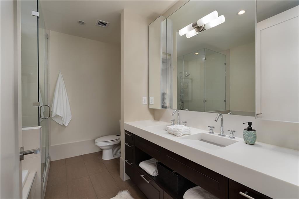 1820 Peachtree Road Northwest, Unit 1408 Atlanta, GA 30309 - Photo 14 of 37 a bathroom with a double vanity sink mirror and toilet