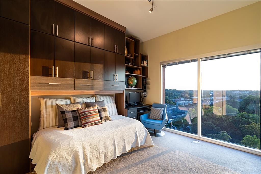 1820 Peachtree Road Northwest, Unit 1408 Atlanta, GA 30309 - Photo 15 of 37 a bedroom with a bed and large window
