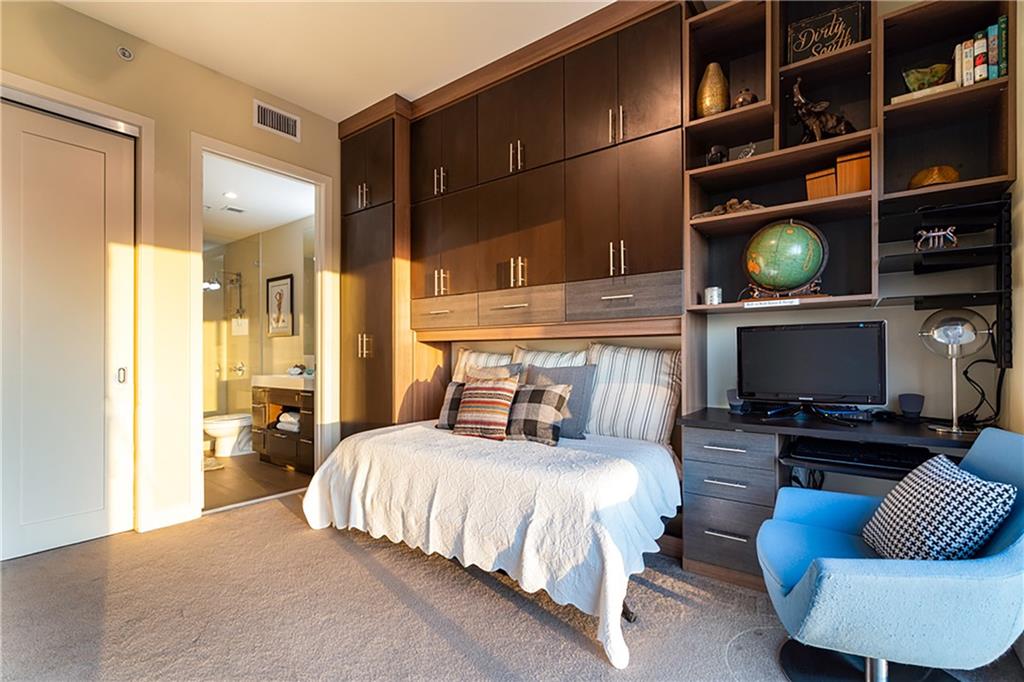 1820 Peachtree Road Northwest, Unit 1408 Atlanta, GA 30309 - Photo 16 of 37 a bedroom with a bed a couch and bookshelf